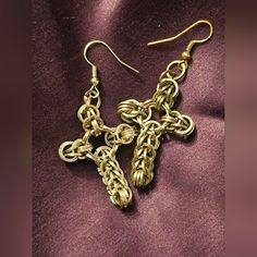 two pairs of gold chainmail earrings on purple fabric