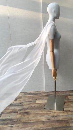 a mannequin with a white cloth draped over it