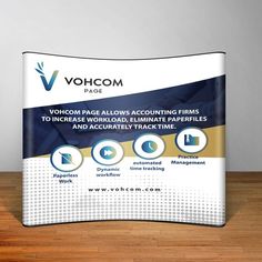 an advertisement for vohcom is displayed on a wooden table in front of a gray wall