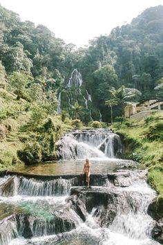 a person standing on top of a waterfall