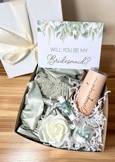 the bridesmaid gift box is filled with personalized items and has a card that says, will you be my bridesmaid?