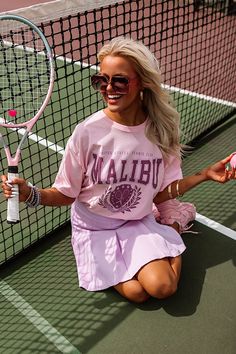 – The perfect casual but chic addition to your look – Lightweight, unlined 100% cotton material – Malibu Tennis Club graphic print – Round neckline – Short, loose sleeves – Relaxed silhouette that ends in a straight hemline Measurements S-M : Bust 44", Hip 44", Length 29", Sleeve Length 8.5", Waist 44". L-XL : Bust 48", Hip 48", Length 30", Sleeve Length 8.5", Waist 48". Oversized Printed Pink Tops, Oversized Pink Printed Tops, Oversized Pink T-shirt For Day Out, Pink Graphic Print T-shirt For Day Out, Pink Letter Print T-shirt For Day Out, Pink Relaxed Fit T-shirt For Day Out, Relaxed Fit Pink T-shirt For Day Out, Tennis Clubs, Distressed Shorts