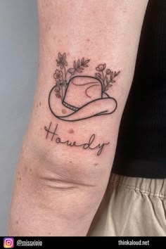 a woman's arm with a hat and flowers on it that says, houndy