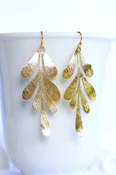 Leaf Earrings golden. Nature Earrings. Statement earrings 18k gold plated. These beautiful leaf earrings are inspired by nature and make a great statement jewelry piece. The gold plated brass pendant is beautifully textured. The earrings are lightweight and comfortable to wear. ❤ Handmade with love I High quality workmanship I Lovingly packaged. ❤ DETAILS Brass 18k gold plated 70x29 mm The earrings are delivered in a elegant jewelry box. ❤ More gold earrings here: https://www.etsy.com/de/shop/Gl Gold Leaf Earrings For Gift, Yellow Gold Leaf Earrings, Gold Single Leaf-shaped Earring, Gold Leaf-shaped Earrings For Gift, Gold Leaf-shaped Pierced Earrings, Gold Leaf-shaped Single Earring, Gold Leaf-shaped Earrings, Yellow Gold Leaf-shaped Earrings For Pierced Ears, Gold-plated Leaf-shaped Earrings