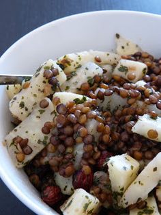 a white bowl filled with beans and cheese