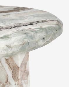 a marble table top with white and grey veining on the edges, against a white background