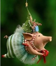 an ornament shaped like a pig with a christmas tree on its head