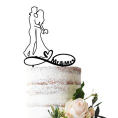 a wedding cake with a bride and groom topper