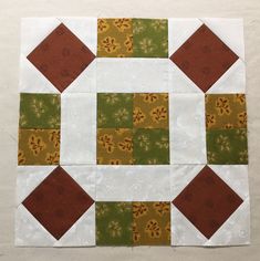 the block is made up of different colors and shapes, including brown, green, yellow and white