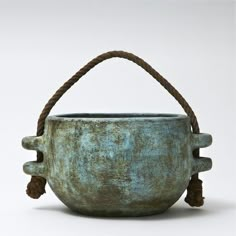 an old metal bucket with rope handles