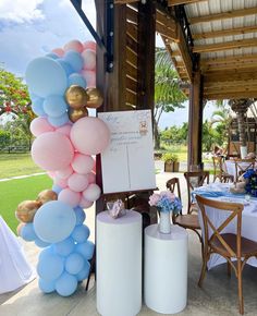 balloons and other decorations are on display at a wedding reception in an outdoor setting with tables and chairs