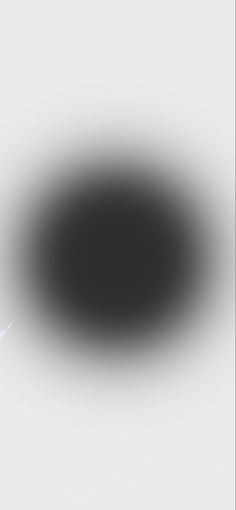 a black and white photo of an object in the middle of the image, it appears to be very dark