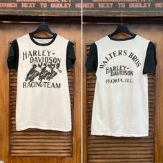 two t - shirts hanging on a wooden door with the words harley davidson racing team printed on them