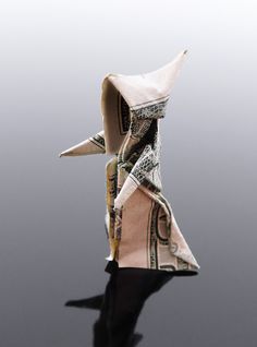 an origami doll made out of dollar bills