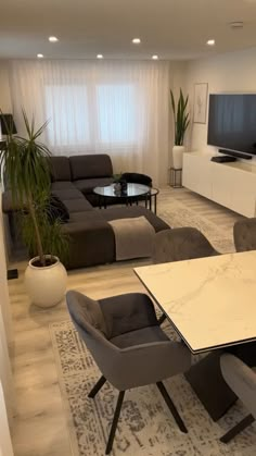 a living room filled with furniture and a flat screen tv on top of a wall