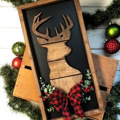 a wooden sign with a deer head on it