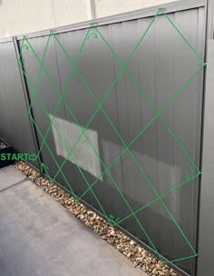 a metal fence with green lines on it