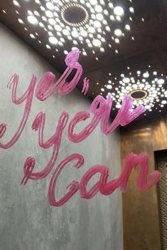 the words you're vegan are painted on a wall in front of a chandelier