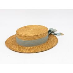 The Ridgemont Make's vintage 1930s boater hat showcases timeless elegance with its natural straw construction. Adorned with a pale blue ribbon and bow, this hat epitomizes classic style. The sturdy yet lightweight straw provides comfort and durability, while the charming ribbon adds a touch of sophistication. This boater hat captures the essence of vintage summer fashion, making it a coveted accessory for collectors and design enthusiasts alike. Seven are available for a display collection. Some Vintage Blue Adjustable Hat Bands, Vintage Flat Crown Hats For Beach, Vintage Flat Crown Hats For The Beach, Vintage Adjustable Boater Hat With Flat Crown, Vintage Hat Bands For Beach With Flat Crown, Vintage Natural Boater Hat With Short Brim, Vintage Hat Bands With Flat Crown For Summer, Vintage Straw Boater Hat With Short Brim, Vintage Straw Boater Hat With Flat Brim