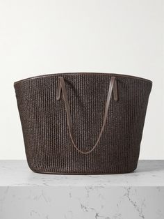 Brunello Cucinelli's tote is perfectly sized for long weekends away or days at the beach. Woven from raffia, it's trimmed with the label's signature Monili beads and has an oversized, open-top design. Use the zipped pocket to keep small essentials secure.