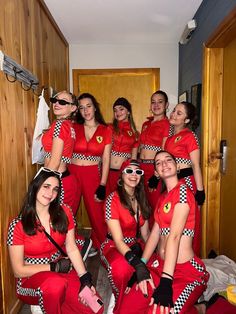 a group of women in matching red outfits posing for a photo with one woman wearing sunglasses