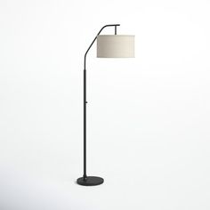 a black floor lamp with a white shade