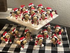 a table topped with lots of stuffed animals on top of a checkered table cloth