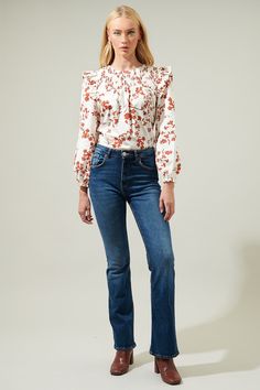 Kick off the season with the Garnet Floral Smocked Top! The beautiful rust floral design overlays white top with ruffles on shoulders followed by long bubble sleeves and an elastic cuff. Its smocked design gives it an extra touch of cuteness followed by a keyhole closure in the back. Perfect top to wear with some denim jeans.- Smocked- Ruffle details- Keyhole- Balloon long sleeves- Color: Rust MulSize + Fit - Model is 5'8" and wearing size XS- Measurements taken from size S - Chest: 21"- Length: Top With Ruffles, Smocked Top, Floral Midi Dress, Sweater Weather, Cotton Style, White Top, White Tops, Best Sellers, Smocking