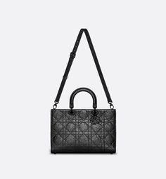 New for the season and appearing in the Spring-Summer 2024 Fashion Show, the Lady D-Sire bag draws inspiration from the iconic elegance of the Lady Dior design. Reimagined with a casual style for an urban look, the black crinkled calfskin is accented by Macrocannage topstitching, while tonal ultra-matte metal D.I.O.R. charms lend a modern touch. Featuring a thin, removable leather shoulder strap, the unique large bag can be carried by hand or worn over the shoulder.. Dior Star, Icon Shoes, Drawing Bag, Dior Book Tote, Wallet Pouch, Backpack Tote Bag, Large Bag, 2024 Fashion, Lady Dior