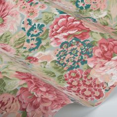 a pink and green floral print fabric with large flowers on the top, in full bloom