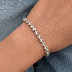 We took a classic tennis bracelet and added vintage charm with delicate milgrain detailing. The bracelet is finished with a box clasp with locking hinge for added security. This bracelet is fully customizable. If you prefer 18k gold or platinum, different dimensions, different quality diamonds or moissanites or colored gemstones, please contact us: http://etsy.me/1231fkN Details: - Solid 14k yellow or white gold - Bracelet is 7 inches in length. For different lengths, please contact us. - SI+G/H Timeless Diamond Tennis Bracelet With Bezel Setting, Timeless Tennis Bracelet With Bezel Setting, Diamond Tennis Bracelet With Bezel Setting For Anniversary, Classic Bezel Setting Tennis Bracelet For Formal Occasions, Formal Diamond White Tennis Bracelet With Bezel Setting, Classic Adjustable Diamond Tennis Bracelet, Adjustable Classic Diamond Tennis Bracelet, Classic Adjustable Tennis Bracelet With Prong Setting, Elegant Diamond White Tennis Bracelet With Bezel Setting