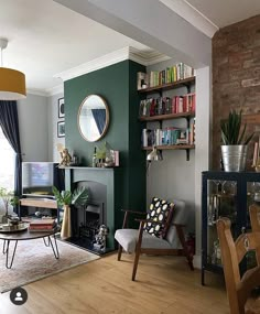 a living room filled with furniture and a fire place in front of a tv mounted on a wall