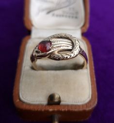 Vintage unisex 9ct yellow gold snake ring, set with a round cut cabochon garnet. The engraved snake is beautifully detailed, with his tail looping around his head. Garnet: 5mm diameter  Hallmark: Maker's mark 'G&PLd', '9 375' for 9ct gold, date letter 'K' for 1965, assay London Size: UK V1/2, EU 64.5, USA 11.25 Weight: 6.2g Condition: The garnet has some surface abrasions commensurate with age and use. The history of garnet dates back to the Bronze Age, more than 5000 years ago. Its name was der Antique Hallmarked Snake Ring, Antique Snake Ring As Gift, Antique 14k Gold Snake Ring Gift, Vintage Snake-shape Jewelry For Formal Occasions, Vintage Engraved Snake Ring As A Gift, Vintage Engraved Snake Ring Gift, Elegant Hallmarked Snake Ring, Heirloom Hallmarked Snake Ring As Gift, Snake-shaped Engraved Rings For Gifts