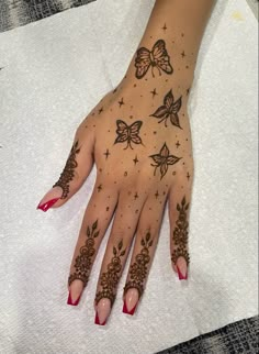 a woman's hand with hendix and butterflies painted on her left arm