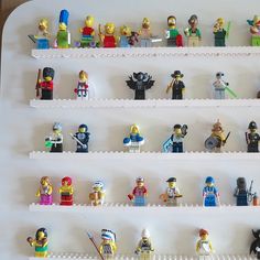 legos are lined up on the wall to display their own characters and colors,