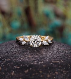 a diamond ring sitting on top of a rock