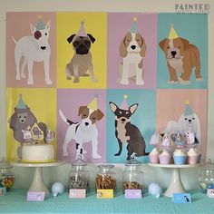 a table with cupcakes, cake and decorations for a dog themed birthday party