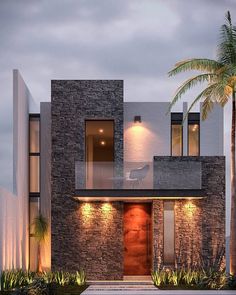 a modern house with stone walls and palm trees