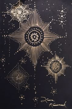 an artistic painting with gold paint and stars on black paper, in the shape of a sun