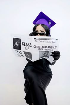 a woman wearing a graduation cap and gown holding a newspaper with the words class of congratulationss printed on it