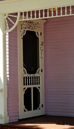 a white door on the side of a purple house