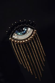 a close up of a brooch on a black background