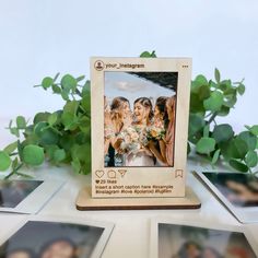 a group of people standing next to each other in front of some pictures on a table