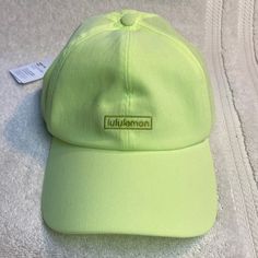 a lime green hat sitting on top of a white towel