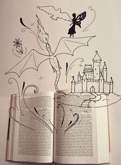 an open book with drawings on the pages and a drawing of a fairy flying over it