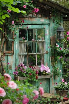 an old window is covered with flowers and plants in front of the door to a house