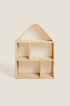 a doll house made out of wood with shelves in the shape of a small house