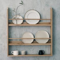 a wooden shelf with plates and cups on it