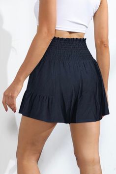 Love skirts but need the comfort and freedom of shorts? Then say hello to the Sawyer Swing Shorts featuring a unique, skirt-like silhouette with a playful ruffle hem and stretchy smocked waist & front tie. These shorts are truly the best of both worlds giving us the freedom & comfort of shorts while maintaining the flirty feminine vibe of a skirt. So go ahead, make a statement in these fun and flirty bottoms. Features: Stretchy Smocked Waist, Ruffle hemline, Front Waist Tie Material composition: Flowy Skirt With Built-in Shorts For Day Out, Stretch Tiered Skirt With Elastic Waistband, Flowy Bottoms With Built-in Shorts For Day Out, Casual Tiered Skirt With Built-in Shorts, Casual Skirted Shorts For Summer, Solid Color Ruffled Beach Skirt, Flirty Stretch Bottoms For Vacation, Vacation Solid Color Short Bottoms, Summer Skirted Bottoms With Built-in Shorts