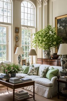 a living room filled with lots of furniture and flowers in vases on the table